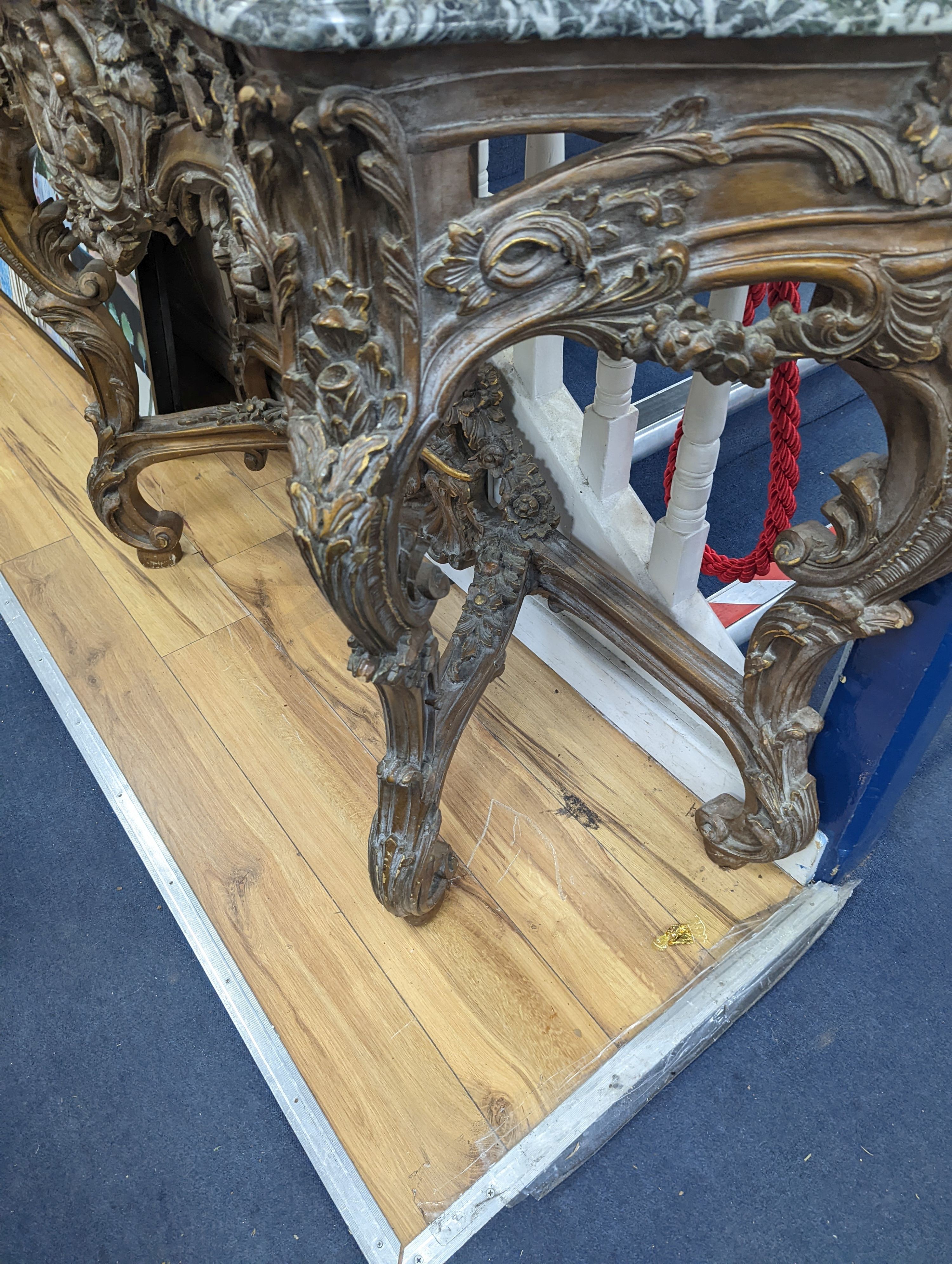 An 18th century style carved giltwood serpentine console table with serpentine marble top, width 140cm, depth 44cm, height 95cm